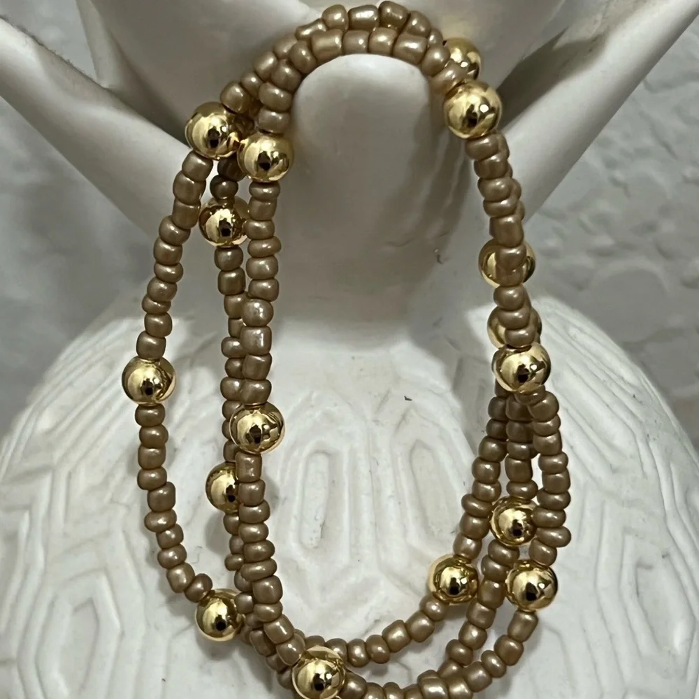 Brown/tan beaded bracelets with gold plated beads size 7”